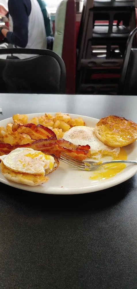 Two Eggs over Easy Bacon Crisp Home Fries Well-Done and an English Muffin
